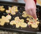 Preparing human shaped cookies made of gingerbread