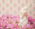 Easter Bunny of white ceramic, on pink daisies