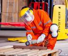 An operator of an industry working in an iron bar. Fully protected to prevent any accident