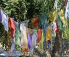 Buddhist prayer flags have their origin in the Himalayas, containing written Tibetan prayers