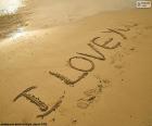 The phrase I LOVE YOU, written in the sand of the beach