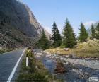 River in the Valley along a narrow mountain road