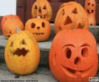 Several pumpkins ready for Halloween, each with a different face