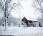 A winter landscape with a snowy barn