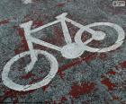 Bike painted on the pavement, indicates that space is reserved for the use of the bicycle