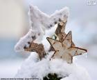 Two-star wooden Christmas partially covered by snow