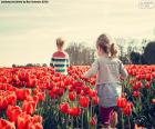 Girls between tulips