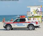 Miami Beach Ocean Rescue vehicle with a surfboard on the roof