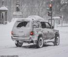 A car going through a fully nevada city in winter