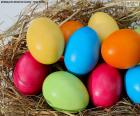 Easter eggs painted in various colors placed in a nest
