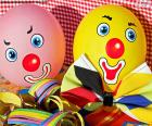 Two balloons with clown's face and other items for a children's Party