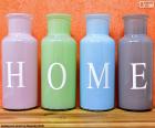 Four bottles with the letters to form the word "HOME"