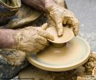 A potter is the person who has the trade make pots, dishes and other vessels of clay