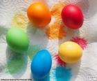 Five Easter eggs painted in different colors, green, blue, yellow, red and orange