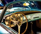 Dashboard of a classic car with wooden steering wheel