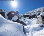 A heart drawn on the snow a sunny winter day
