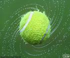 A tennis ball wet after a rainy day