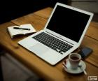 Work table with a MacBook Air, a very thin &amp; light laptop