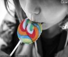 Girl eating a lollipop colors