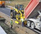 A few operators working on the side of a road