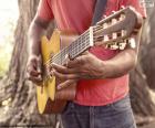 A man playing the guitar on the street