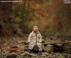 A child amazed by the beauty of the forest in the autumn