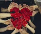 A magnificent heart made up of hands painted red