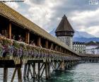 Kapellbrücke, is a wooden bridge that crosses the river Reuss and one of the main tourist attractions of the city of Lucerne in Switzerland