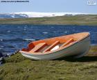 A wooden boat on the shore of the Norwegian Sea