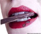 Woman eating a piece of chocolate