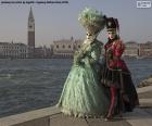 An elegant couple with the classic costumes of the Venice Carnival