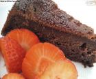 A delicious chocolate cake accompanied by strawberries