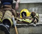 A firefighter resting after working on extinguishing a fire