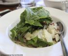 A healthy green leafy salads with Parmesan cheese, a light and refreshing dish for hot days