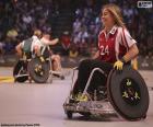 Athlete with a physical disability with a wheelchair adapted to play sport during a competition