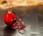 Nice picture of a red Christmas ball with a red ribbon to hang on the tree