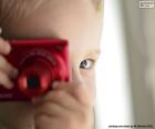 A child playing photographer with a digital camera