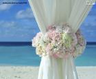 Floral decoration on the curtains of a wedding on the beach