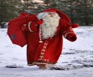 Santa Claus carrying the big bag of Christmas gifts in the woods puzzle