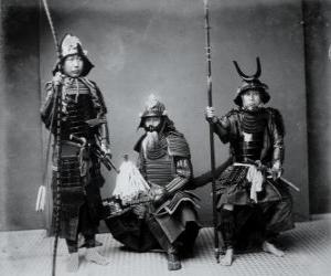 Three authentic samurai warriors, with the armor, the helmet kabuto and armed puzzle