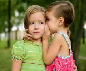 Two girls making confidences puzzle